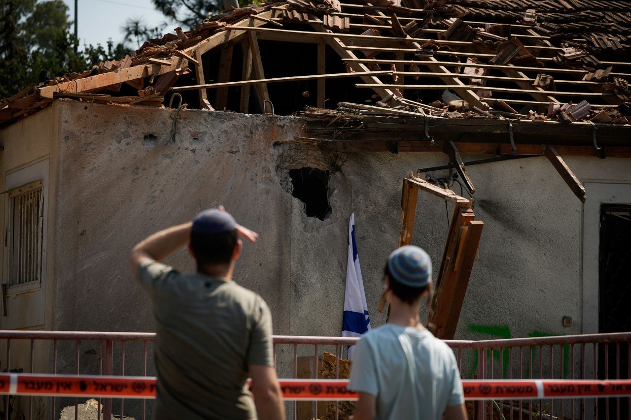 People look at a damaged house that was hit by a rocket fired from Lebanon, near Safed, northern Israel, on September 25, 2024.