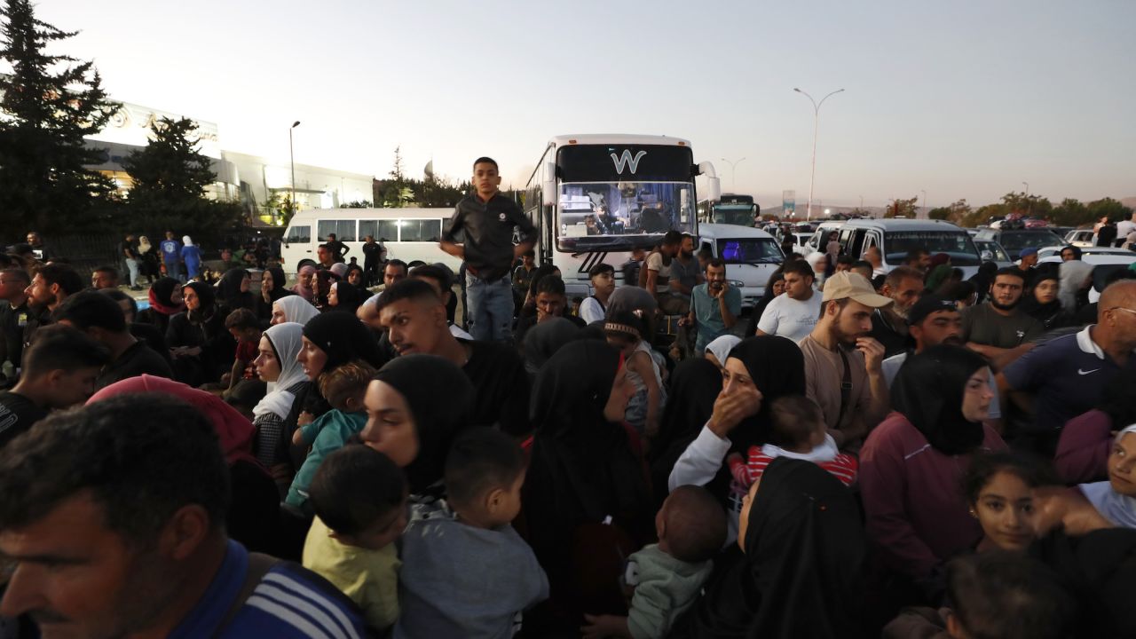 Syrians fleeing Lebanon arrive at the Syrian-Lebanese border crossing in Jdeidet Yabous, Syria, on Wednesday.