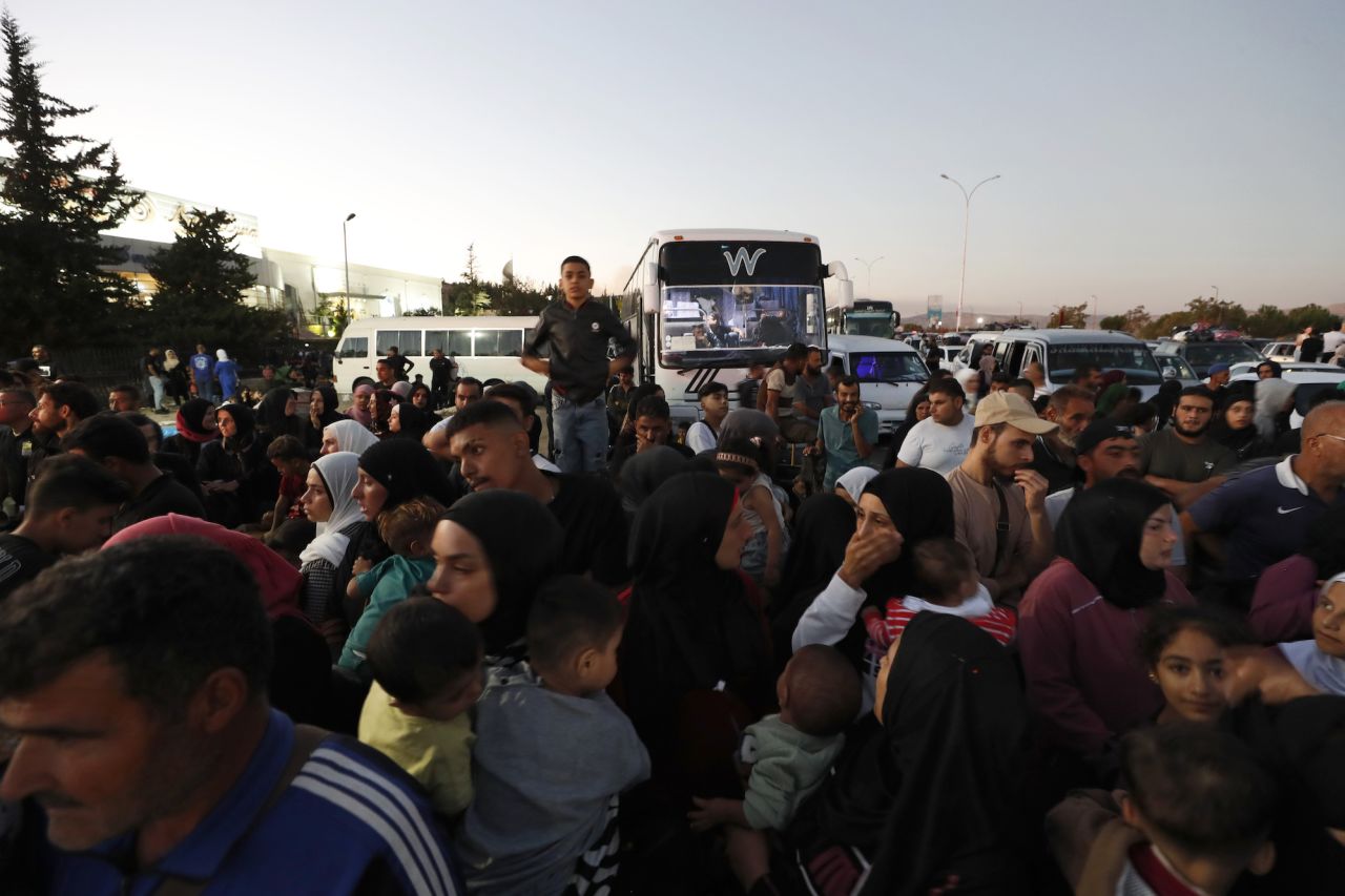 Syrians fleeing Lebanon arrive at the Syrian-Lebanese border crossing in Jdeidet Yabous, Syria, on Wednesday.