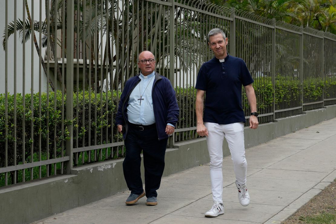 Vatican investigators Monsignor Jordi Bertomeu, right, from Spain, and Archbishop Charles Scicluna, from Malta, walk outside of the Nunciatura Apostolica during a break from meeting with people who alleged abuse by the Catholic lay group Sodalitium Christianae Vitae in Lima, Peru, on July 25, 2023.