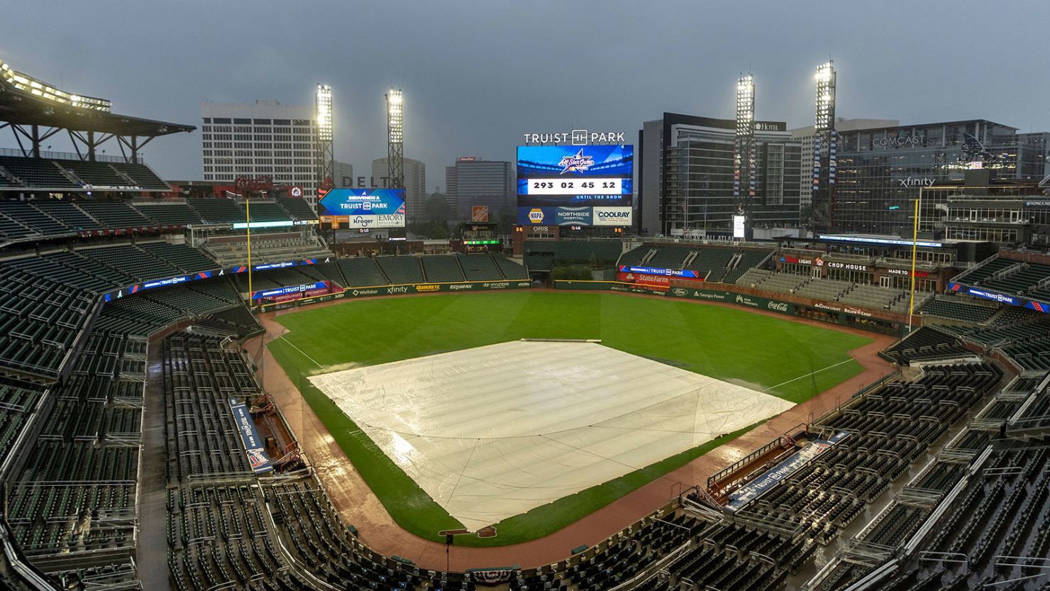 A tarp covers the infield as rain comes down at Truist Park in Atlanta after both Wednesday and Thursday New York Mets-Atlanta Braves games were postponed due to inclement weather.