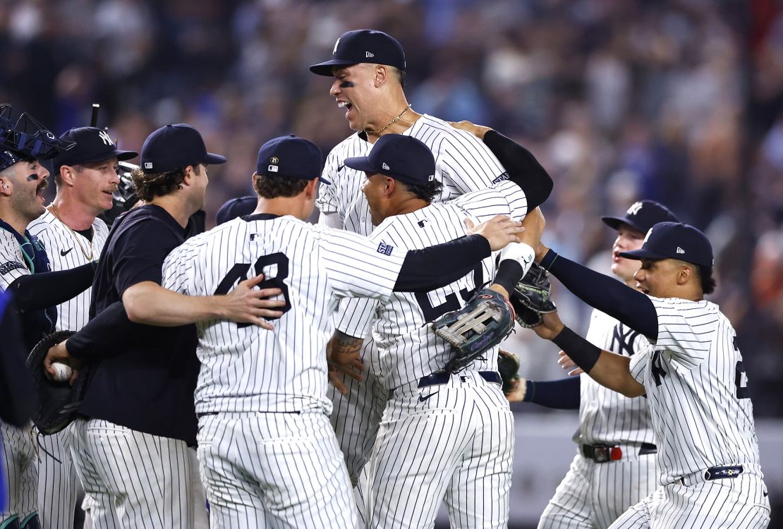 The New York Yankees, including Aaron Judge, celebrate after securing the American League East title.