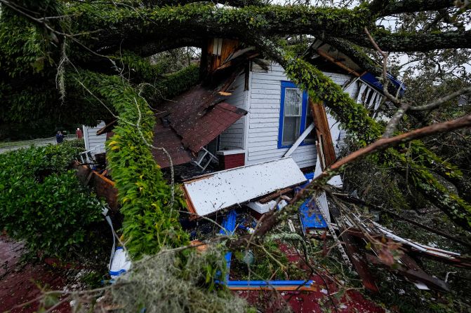 A tree lies on a house in Valdosta, Georgia, on September 27.