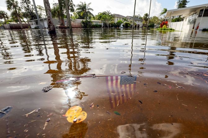 An American flag sits in floodwaters in the Shore Acres neighborhood of St. Petersburg, Florida, on Friday.