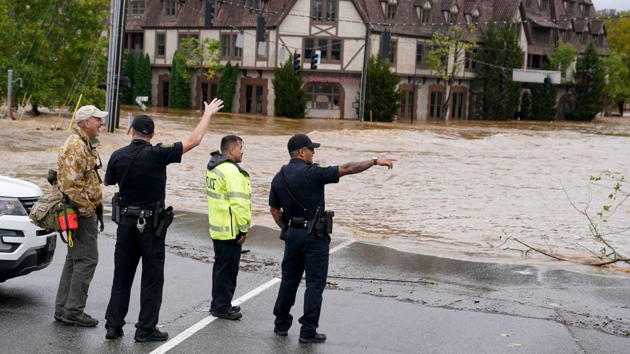 Emergency personnel watch as floodwaters rise, in Asheville, North Carolina, on Friday, September 27.