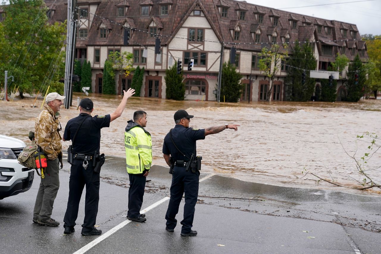 Emergency personnel watch as floodwaters rise, in Asheville, North Carolina, on Friday, September 27.