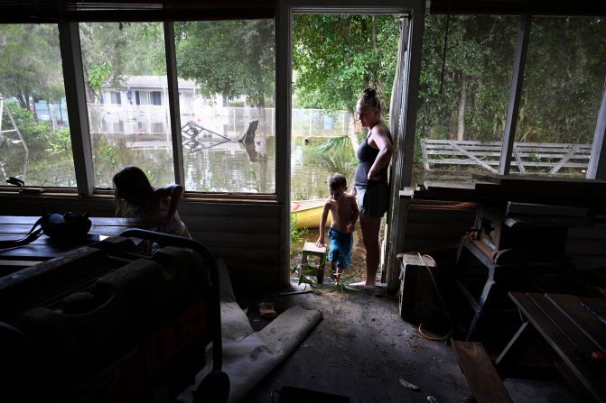 Hailey Morgan, right, surveys the damage to her flooded home after returning with her children, in the aftermath of Hurricane Helene, in Crystal River, Florida, on Friday.