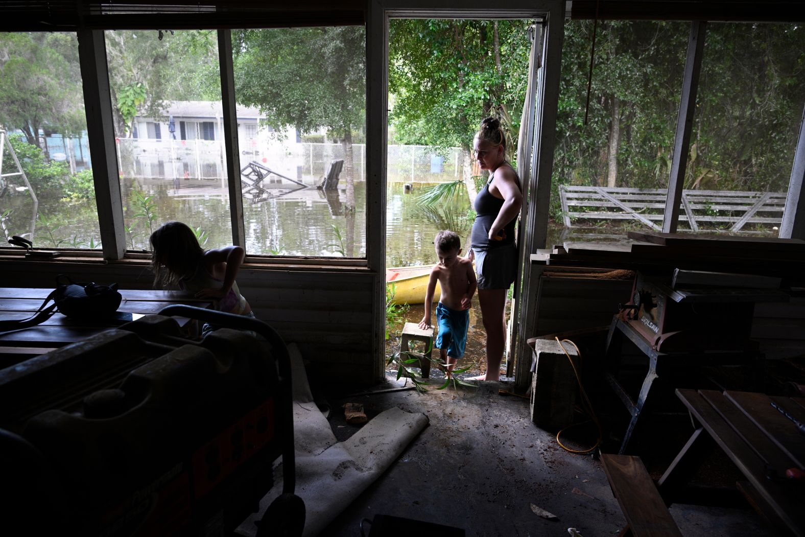 Hailey Morgan, right, surveys the damage to her flooded home after returning with her children, in the aftermath of Hurricane Helene, in Crystal River on Friday.