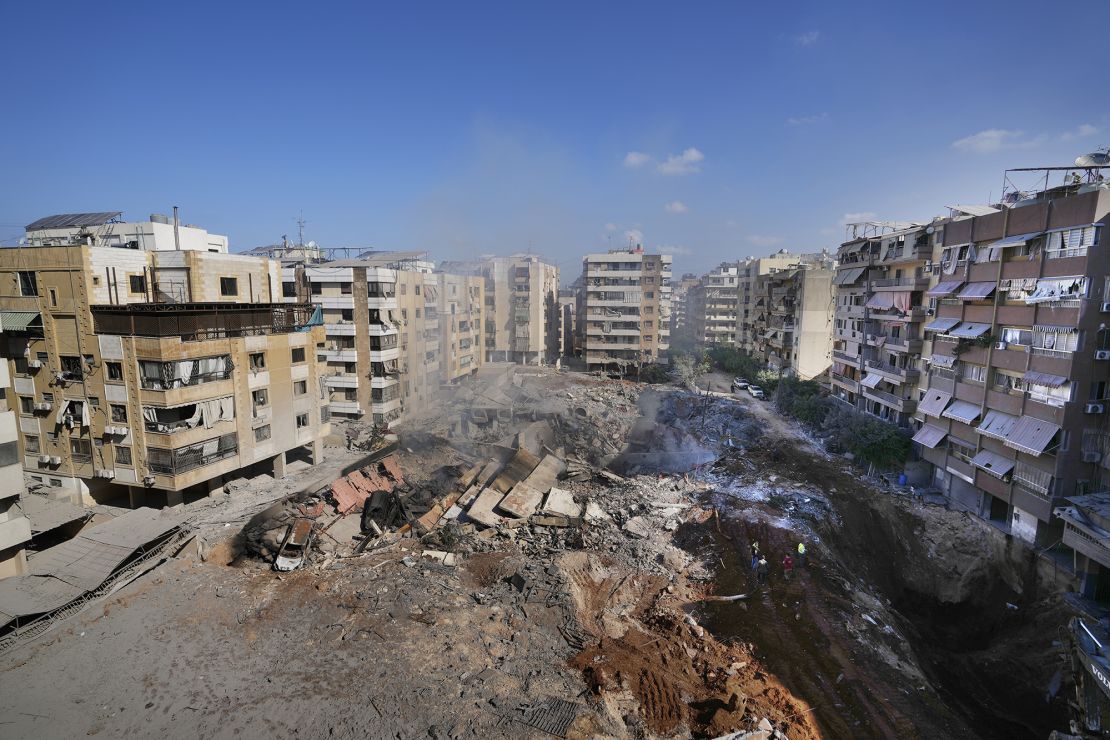 People gather at the site of the assassination of Hezbollah's leader Hassan Nasrallah in Beirut's southern suburbs on Sunday, September 29, 2024.