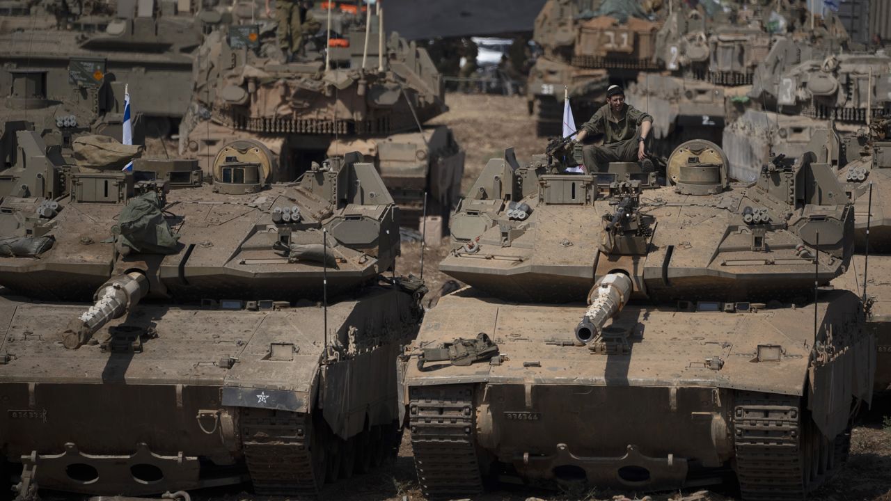 An Israeli soldier sits on the top of a tank, in northern Israel, on September 30.