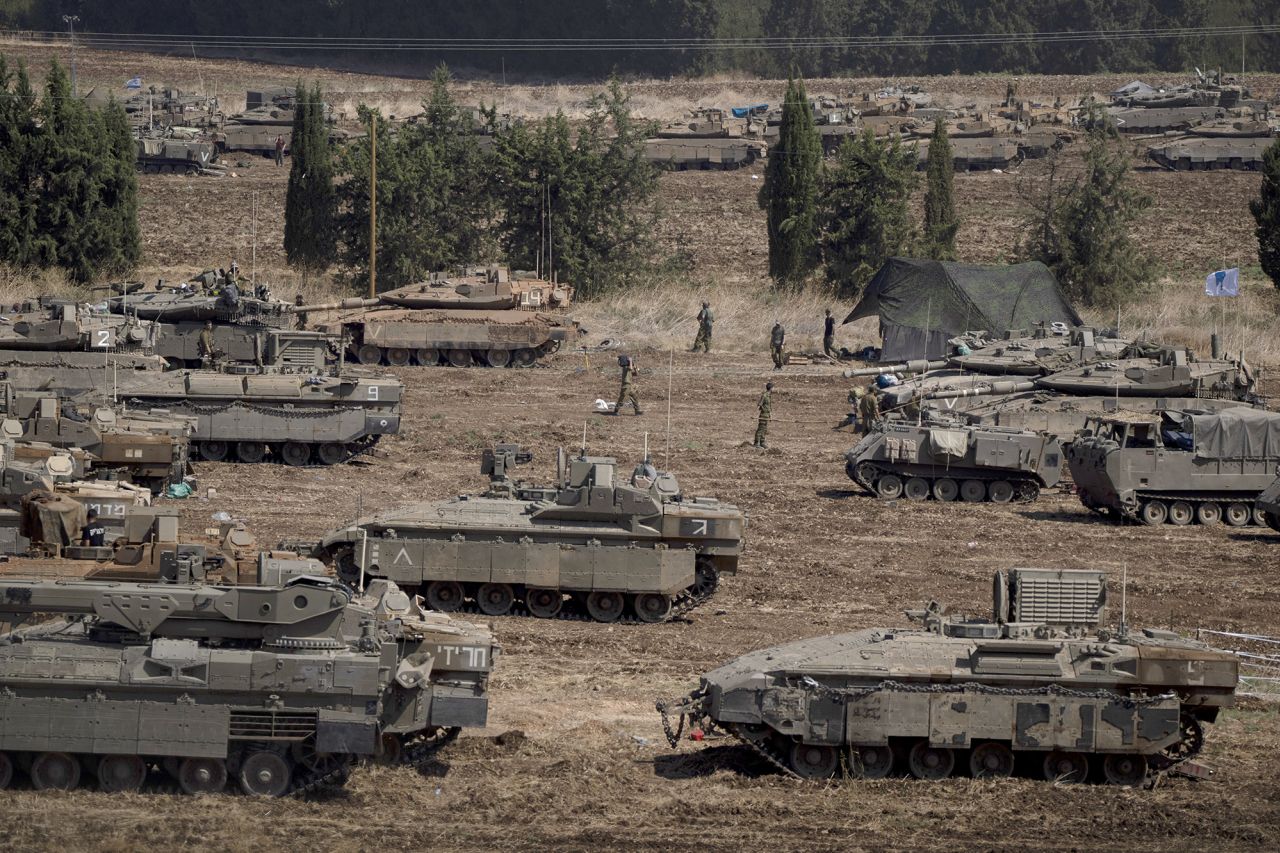 Israeli soldiers work on tanks and armoured personnel carriers in northern Israel, on September 30.