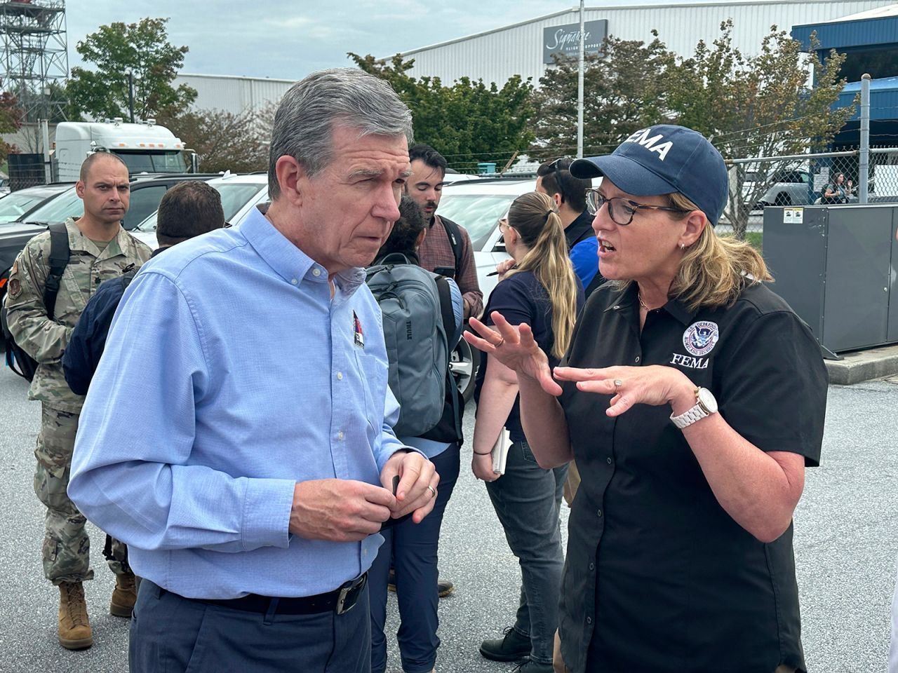 North Carolina Gov. Roy Cooper speaks with FEMA Administrator Deanne Criswell at the Asheville Regional Airport in Fletcher, North Carolina, on September 30.