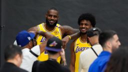 Los Angeles Lakers' LeBron James, left, and his son, Bronny James, pose for photos during the NBA basketball team's media day in El Segundo, Calif., on September 30, 2024.