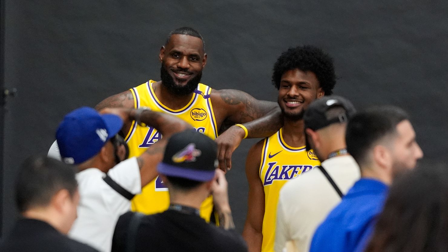 Los Angeles Lakers' LeBron James, left, and his son, Bronny James, pose for photos during the NBA basketball team's media day in El Segundo, Calif., on September 30.