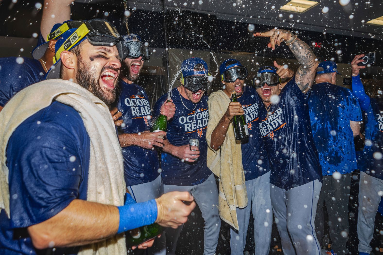 The New York Mets celebrate in the locker room after clinching a playoff berth with a win in Atlanta on Monday, September 30.