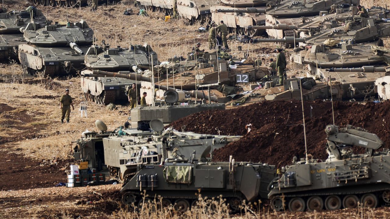 Israeli soldiers work on tanks at a staging area in northern Israel near the Israel-Lebanon border, Tuesday, Oct. 1, 2024. (AP Photo/Baz Ratner)