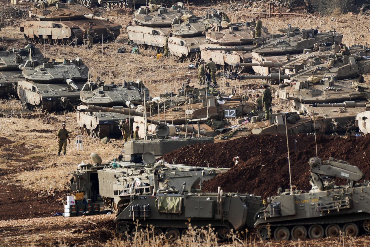 Israeli soldiers work on tanks at a staging area in northern Israel near the Israel-Lebanon border, on October 1.