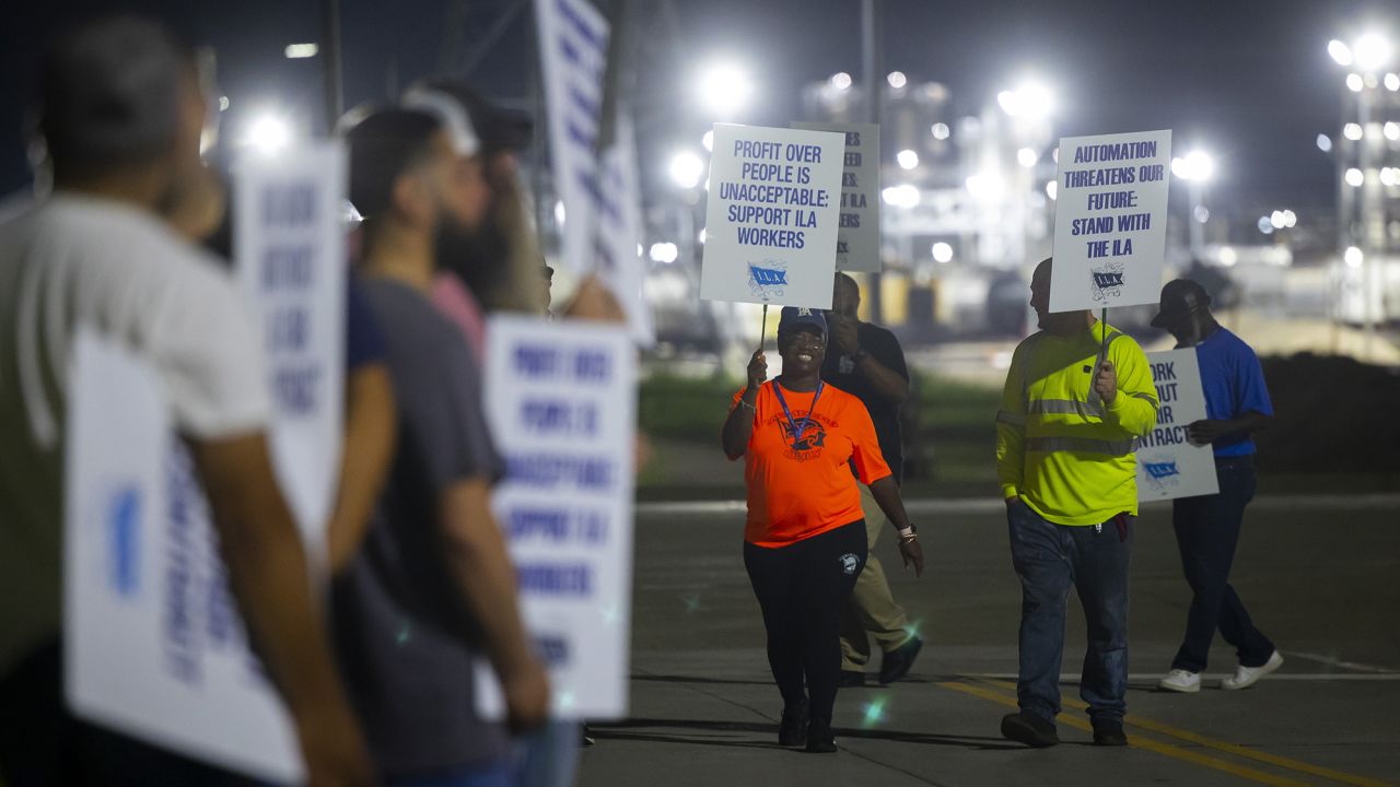 Longshoremen chant as they circle the entrance at Bayport Terminal on Tuesday, Oct. 1, 2024, in Houston.