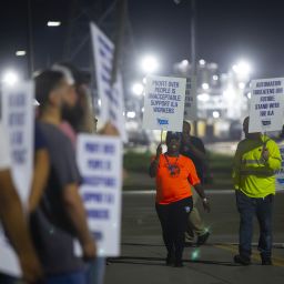 Longshoremen chant as they circle the entrance at Bayport Terminal on Tuesday, Oct. 1, 2024, in Houston.