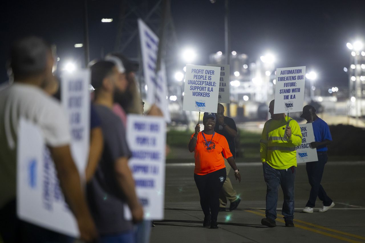 Longshoremen chant as they circle the entrance at Bayport Terminal on Tuesday, Oct. 1, 2024, in Houston.