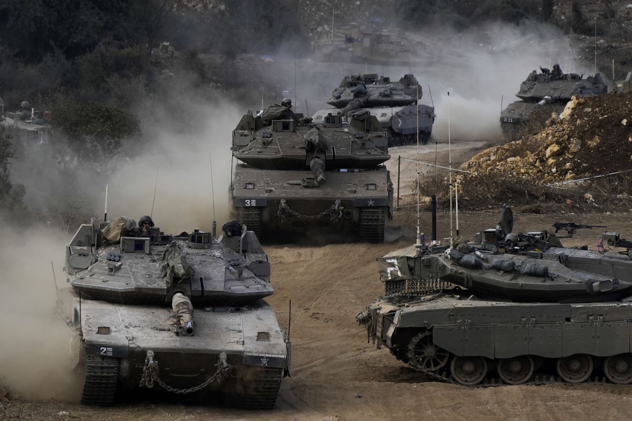 Israeli army tanks maneuver in a staging area in northern Israel, near the Lebanon border, on October 1.