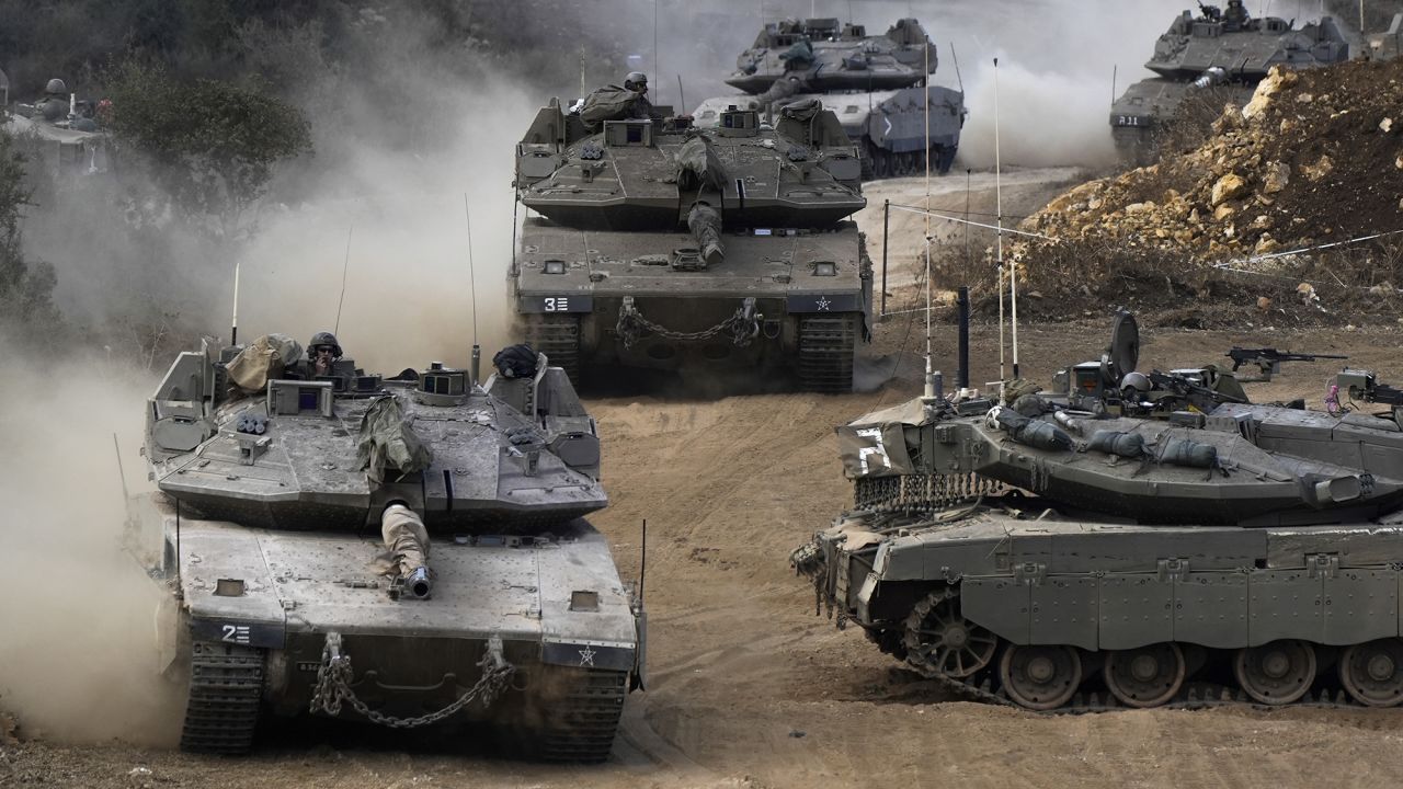 Israeli army tanks manoeuvre in a staging area in northern Israel near the Israel-Lebanon border, on October 1.