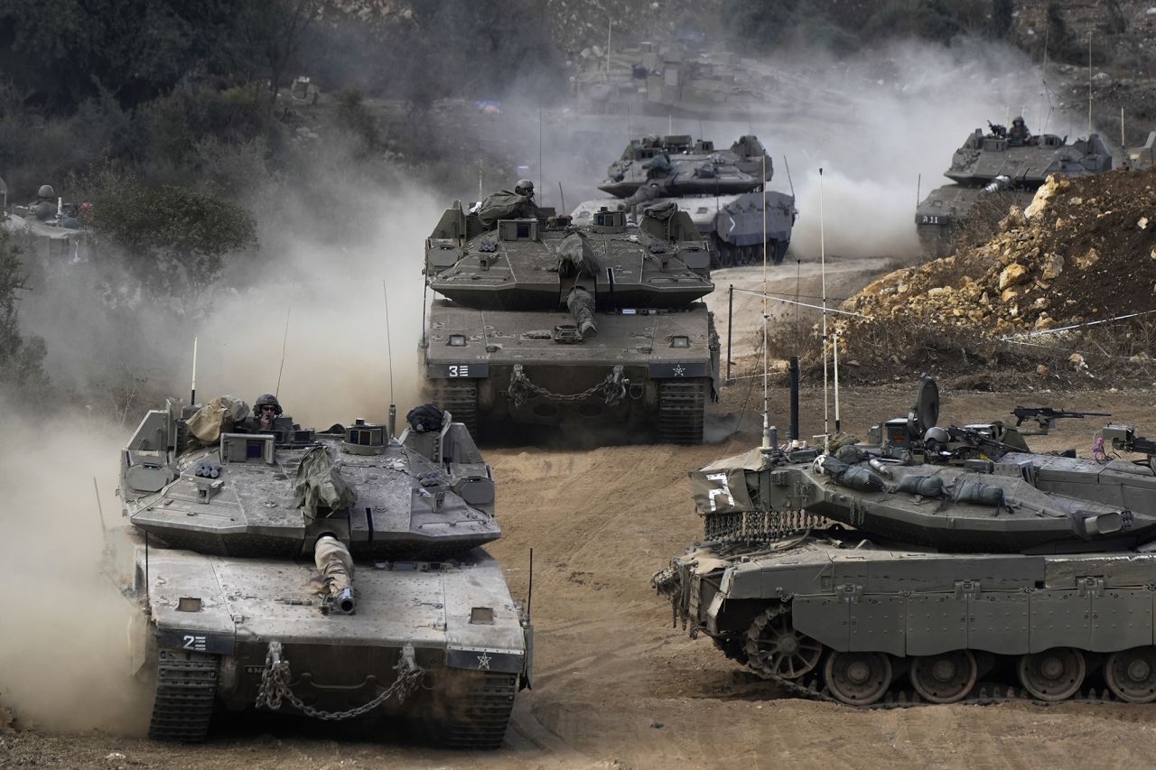 Israeli army tanks manoeuvre in a staging area in northern Israel near the Israel-Lebanon border, on October 1.