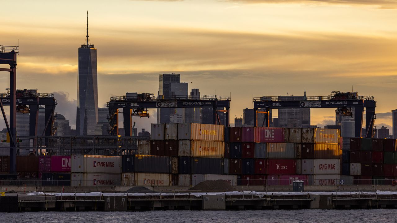 Cranes and shipping containers are seen at Port Jersey with the New York City skyline in the background during a port strike on October 1 in Bayonne, New Jersey.