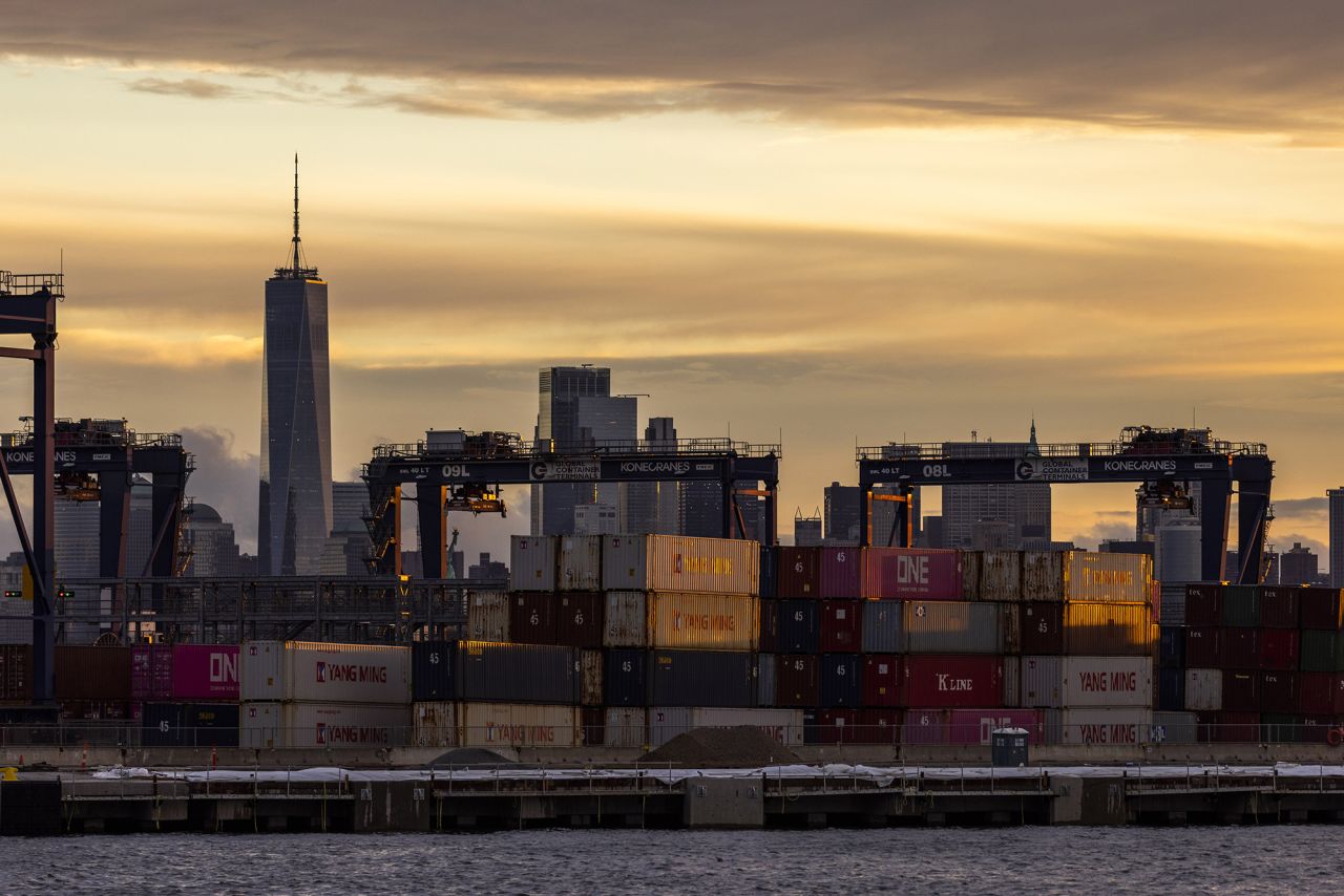 Cranes and shipping containers are seen at Port Jersey with the New York City skyline in the background during a port strike on October 1 in Bayonne, New Jersey.