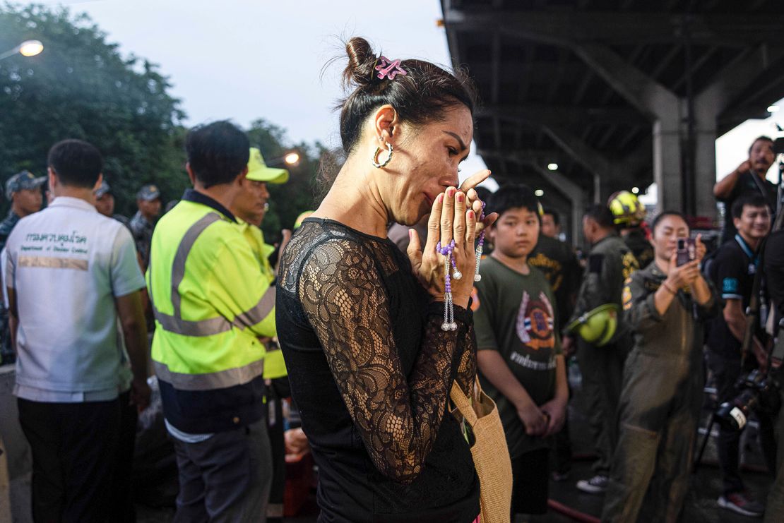 A woman seen crying after the bus accident that was carrying students and teachers on Vibhavadi Rangsit road at the outskirts of Bangkok.