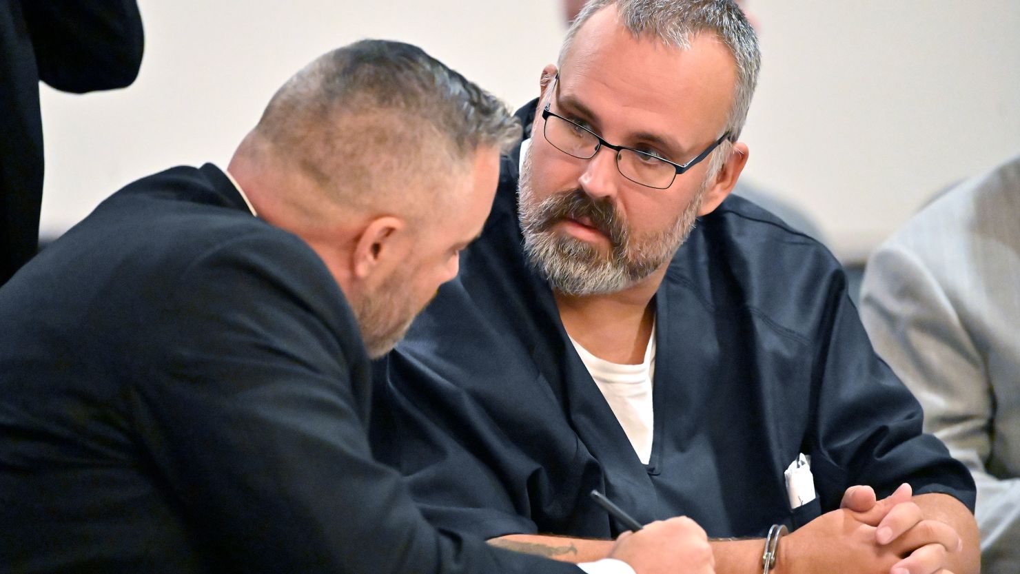 Former Letcher County Sheriff Shawn "Mickey" Stines, right, confers with his attorney Jeremy Bartley during his preliminary hearing at the Morgan County Courthouse. Stines is charged in the shooting death of District Judge Kevin Mullins.
