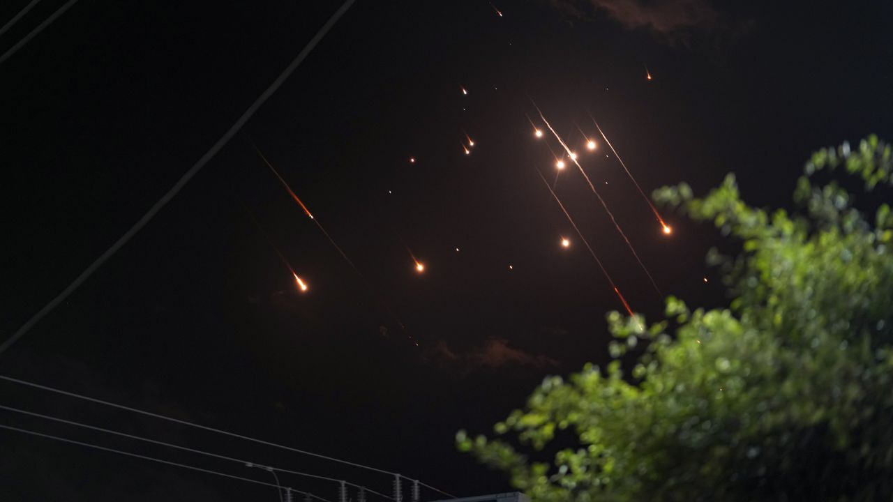 Missiles launched from Iran towards Israel streak across the night sky as seen from Deir al-Balah, Gaza.