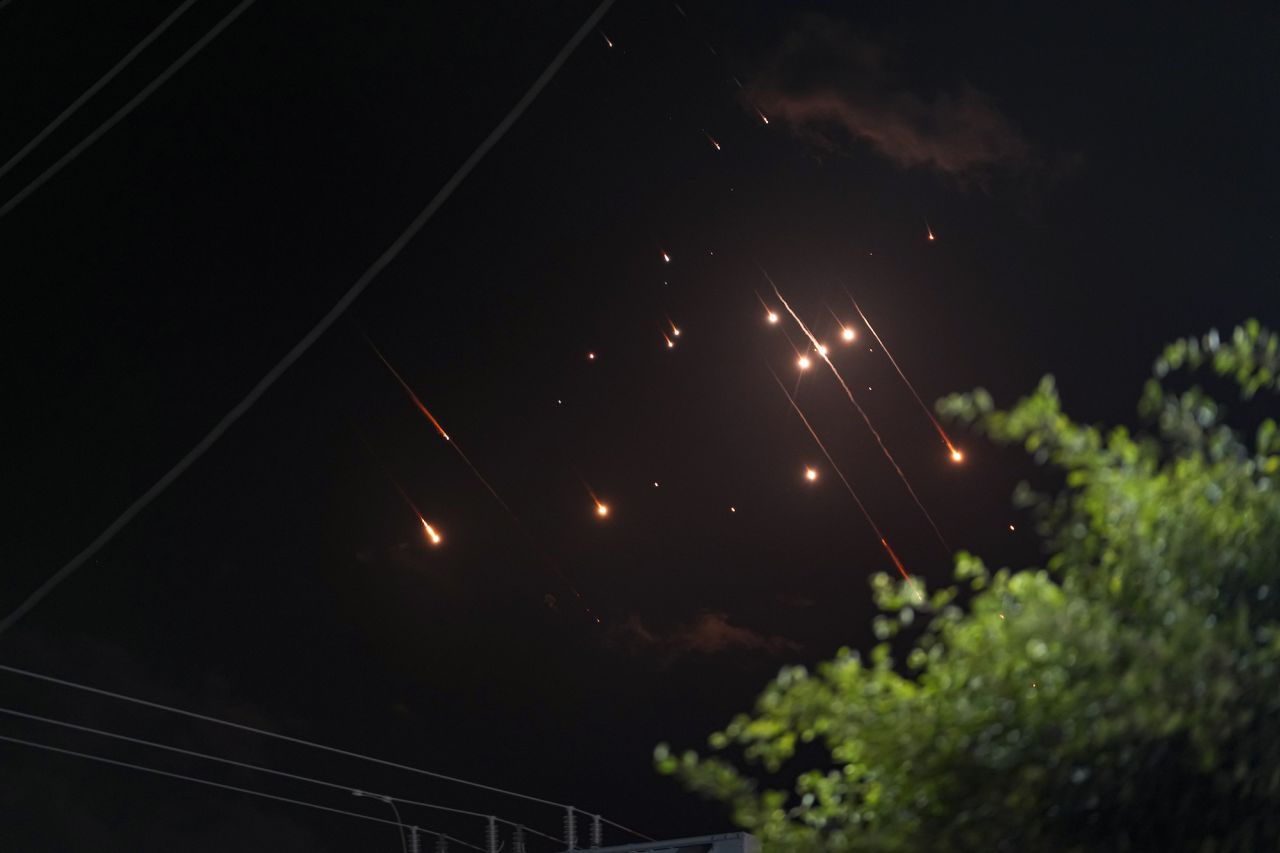 Missiles launched from Iran towards Israel streak across the night sky as seen from Deir al-Balah, Gaza.