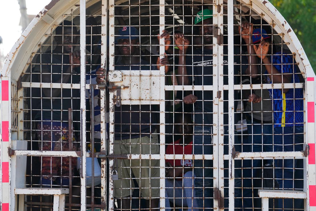 Undocumented Haitians detained by immigration officials stand inside a police vehicle, in Dajabon, Dominican Republic, May 17, 2024.