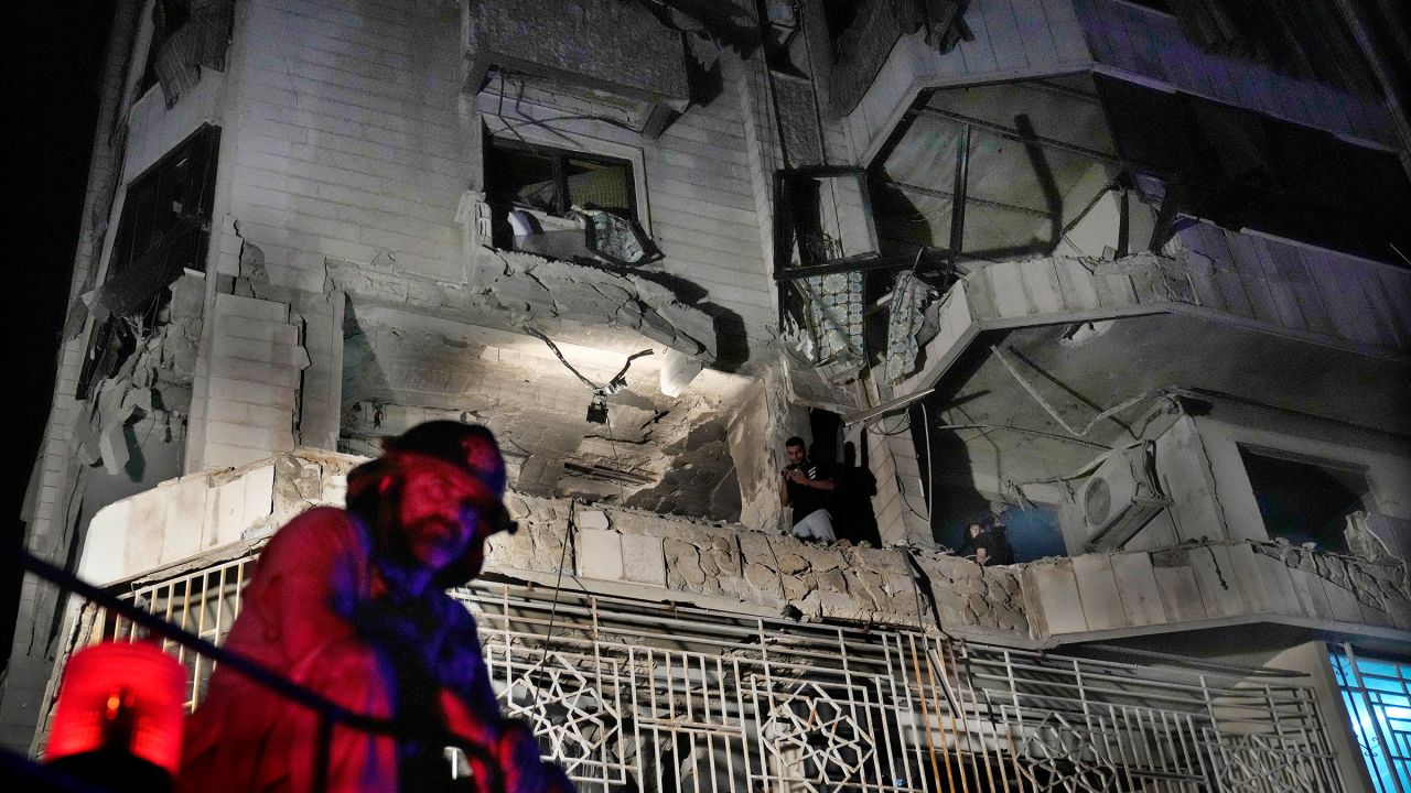 A firefighter stands in front of an apartment hit by an Israeli airstrike, in Beirut, Lebanon, on October 3, 2024.