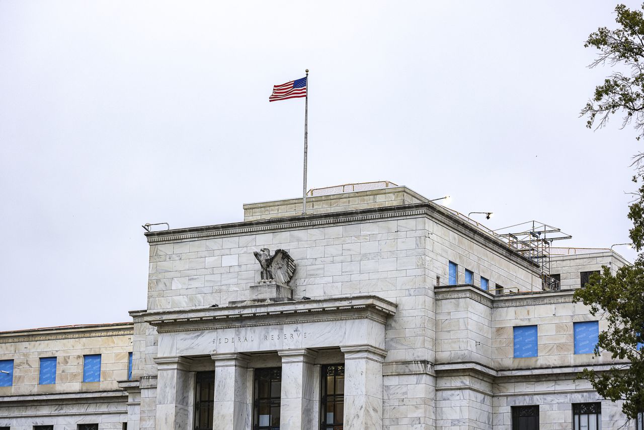 The US flag flies over the Federal Reserve in Washington on October 3.