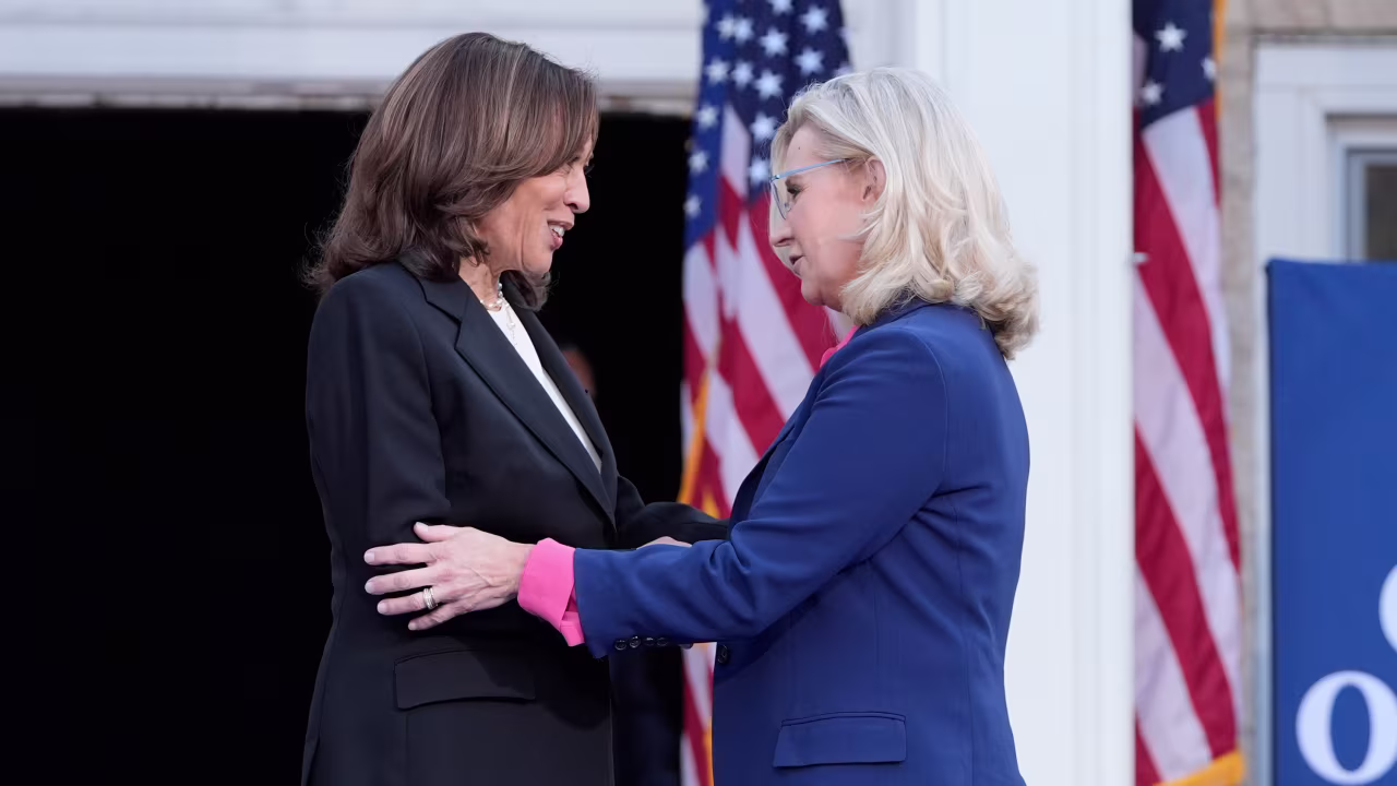 Kamala Harris, left, is greeted by Liz Cheney, during a campaign event at Ripon College in Ripon, Wisconsin, on October 3.