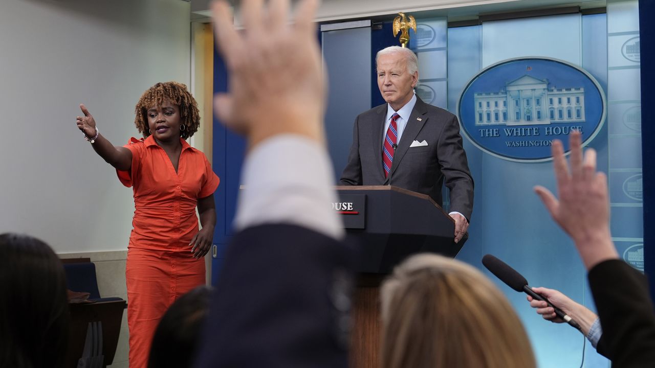 President Joe Biden, standing with White House press secretary Karine Jean-Pierre, speaks during a surprise appearance to take questions during the daily briefing at the White House in Washington, DC, on Friday.