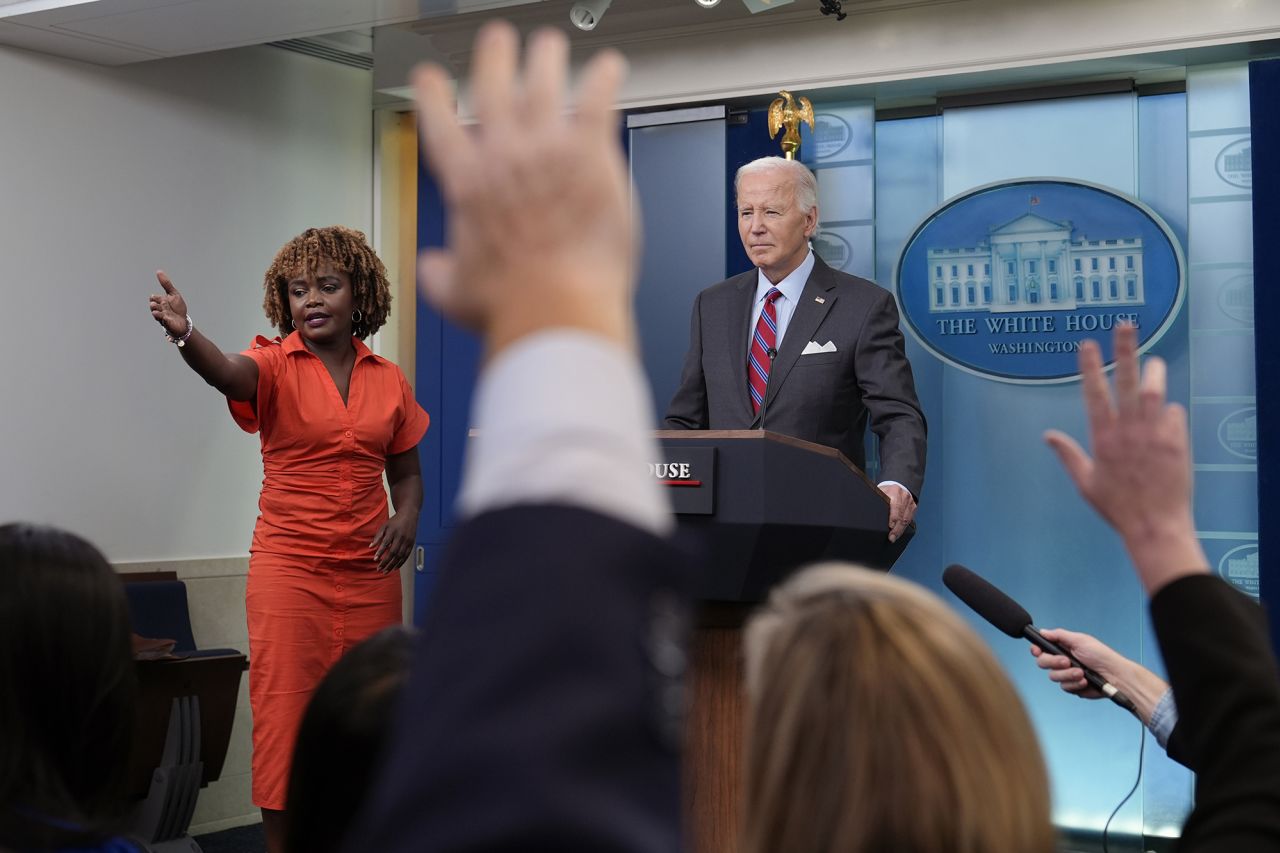 President Joe Biden, standing with White House press secretary Karine Jean-Pierre, speaks during a surprise appearance to take questions during the daily briefing at the White House in Washington, DC, on Friday.