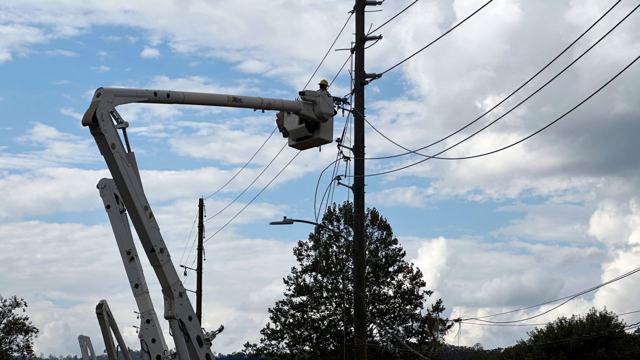 Contractors for Duke Energy rebuild destroyed electrical lines in Asheville, North Carolina, on October 4.