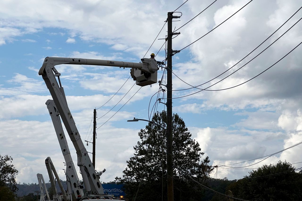 Contractors for Duke Energy rebuild destroyed electrical lines in Asheville, North Carolina, on October 4.