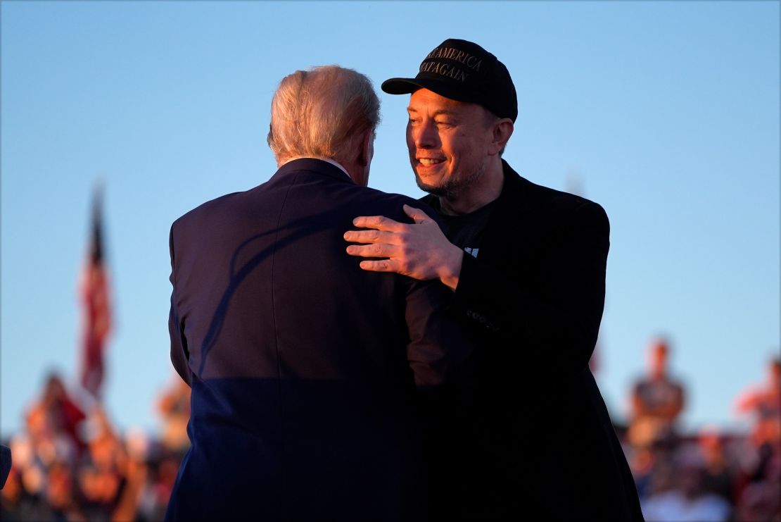 Trump hugs Tesla CEO Elon Musk at a campaign rally in Butler, Pennsylvania, on October 5, 2024.