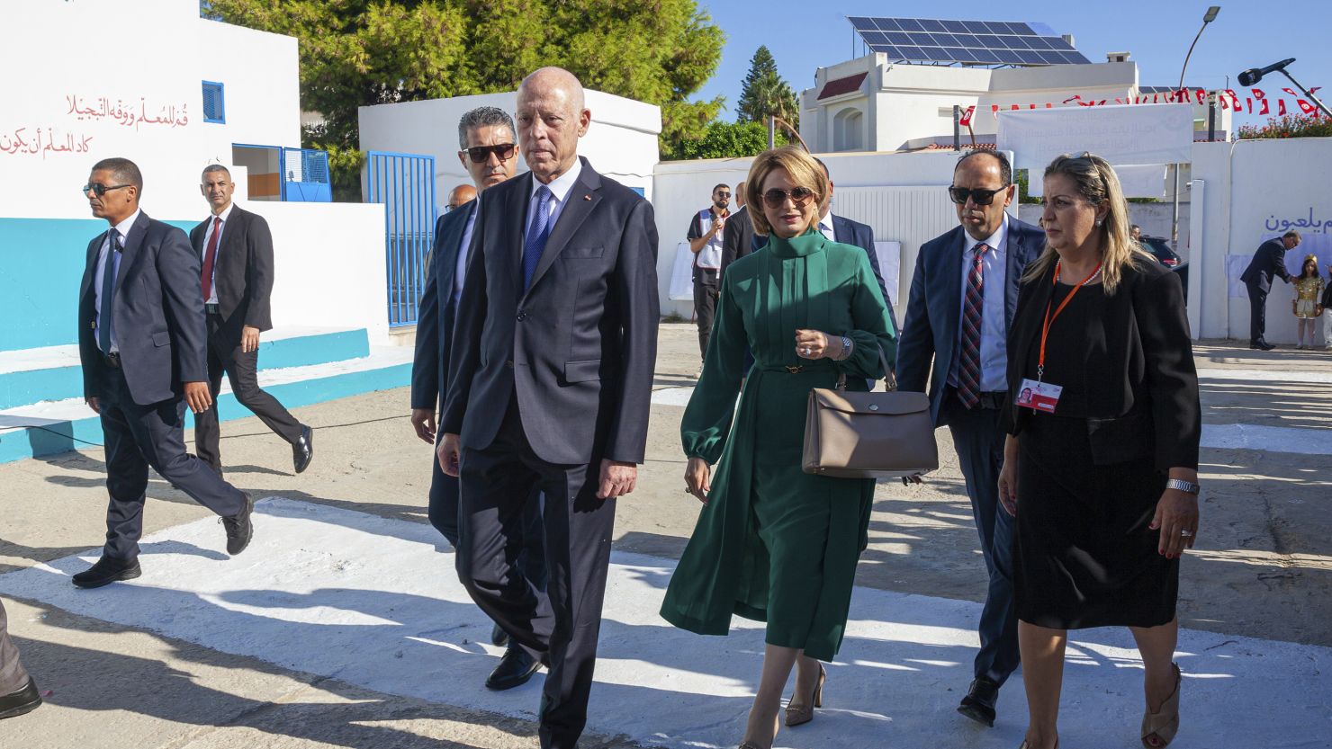 The Tunisian president and candidate for re-election, Kais Saied, front, and his wife Ichraf Chebil Saied arrive at a polling station to cast their votes in the capital Tunis on Oct. 6, 2024.