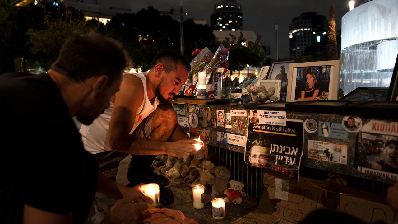 People light candles at a memorial for the victims of the October 7 Hamas cross-border attack on Israel, on the eve of the one-year anniversary of the attack, in Tel Aviv, Israel, Sunday, October 6, 2024.