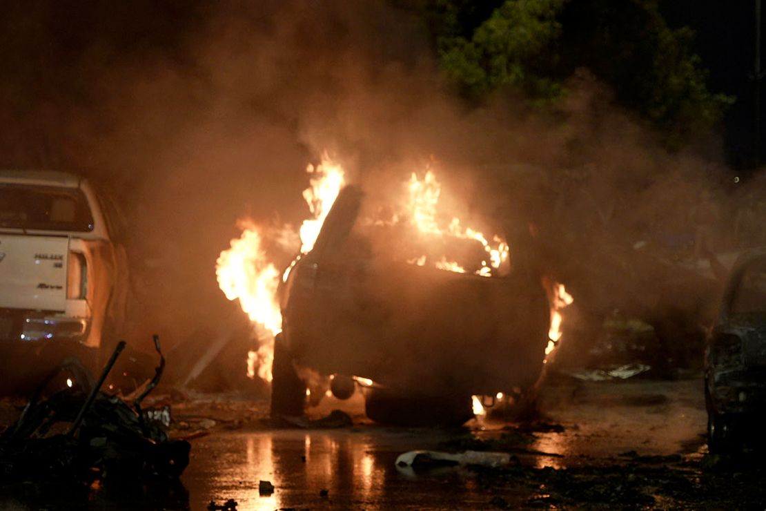 A vehicle is seen on fire at the site of an explosion that caused injures and destroyed vehicles at outside the Karachi airport, Pakistan, Sunday, Oct. 6.