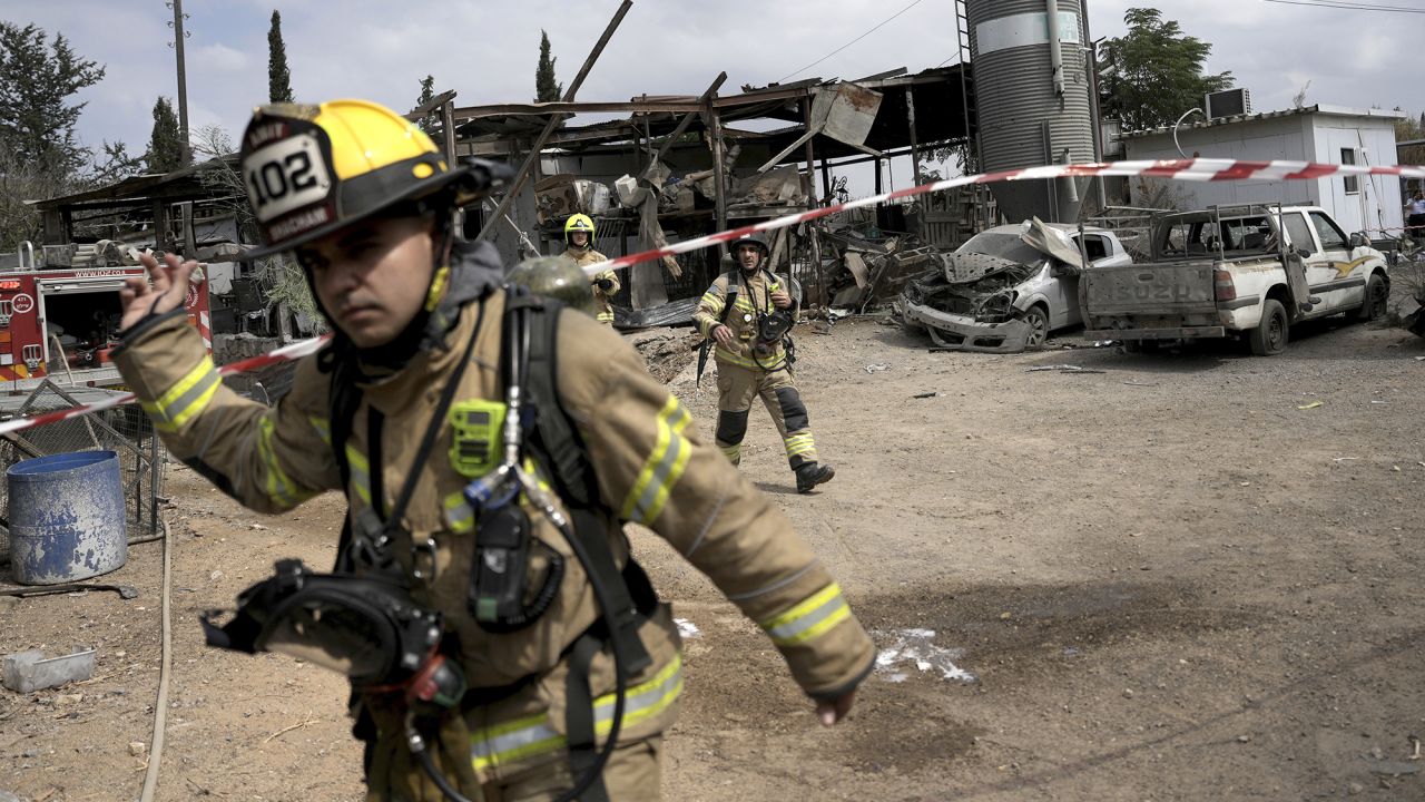 Emergency personnel respond after a rocket apparently fired from Gaza hits Kfar Chabad near Tel Aviv, Israel, on October 7.