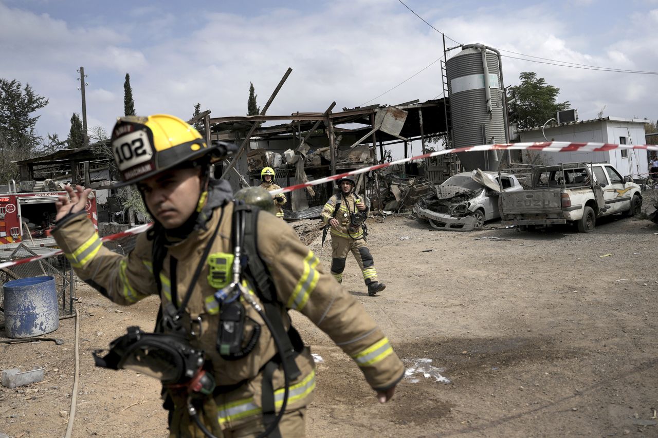 Emergency personnel respond after a rocket apparently fired from Gaza hits Kfar Chabad near Tel Aviv, Israel, on October 7.