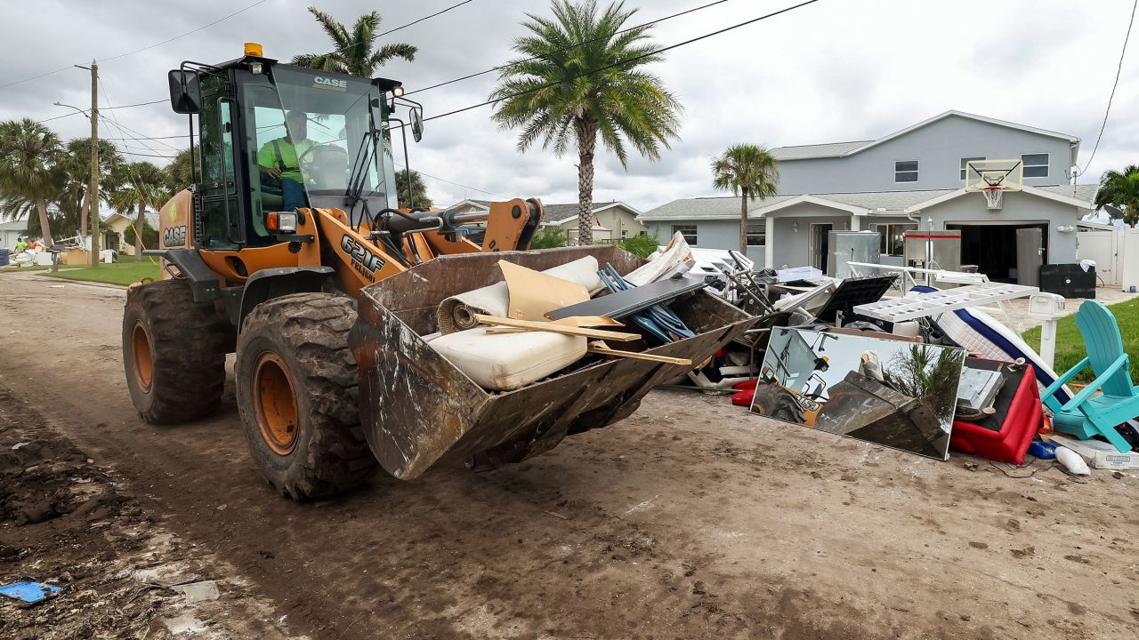 Contractors with the City of New Port Richey help clean debris left by Hurricane Helene in preparation for Hurricane Milton on October 7 in New Port Richey, Florida.