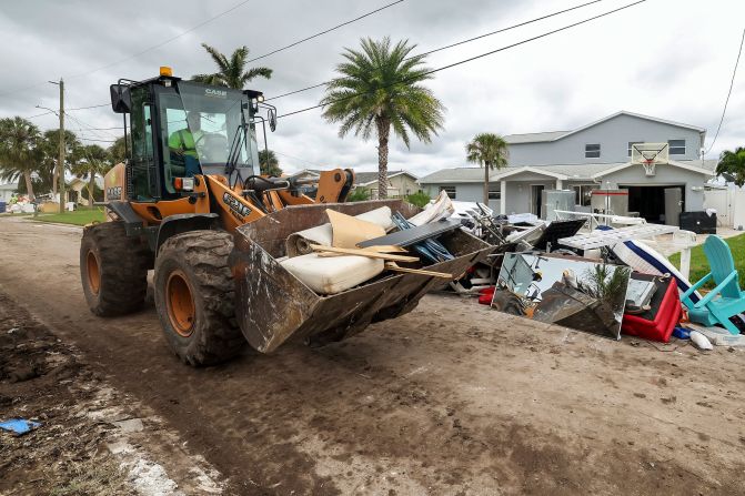 Contractors in New Port Richey help clean debris left by Hurricane Helene.