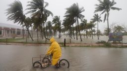 A person rides his bike through a flooded street in the rain as Hurricane Milton passes off the coast of Progreso, Yucatan state, Mexico, Tuesday, Oct. 8, 2024. (AP Photo/Martin Zetina)